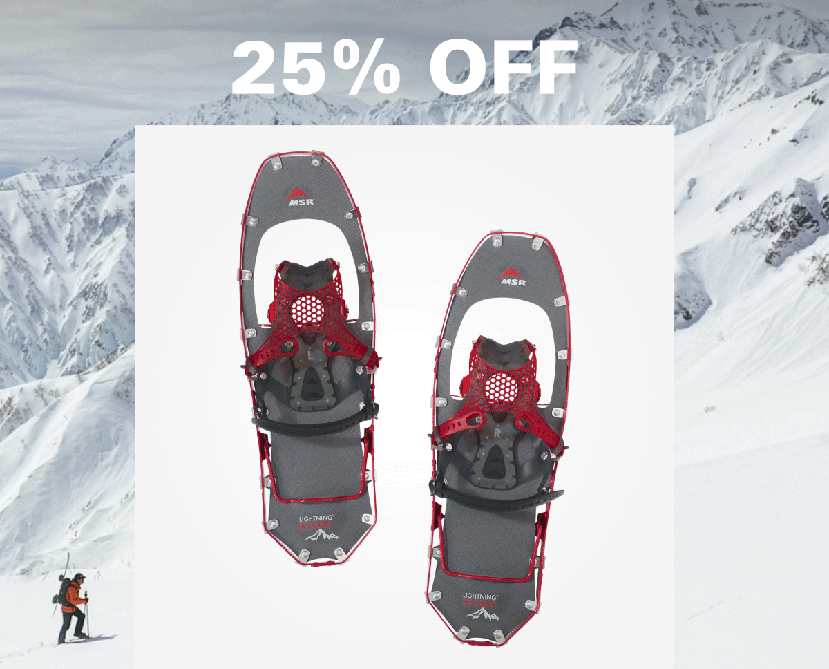 an image of a pair of snowshoes with a man walking in the background