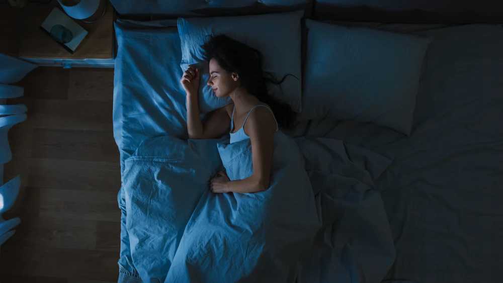 Woman Sleeping in Dark Room