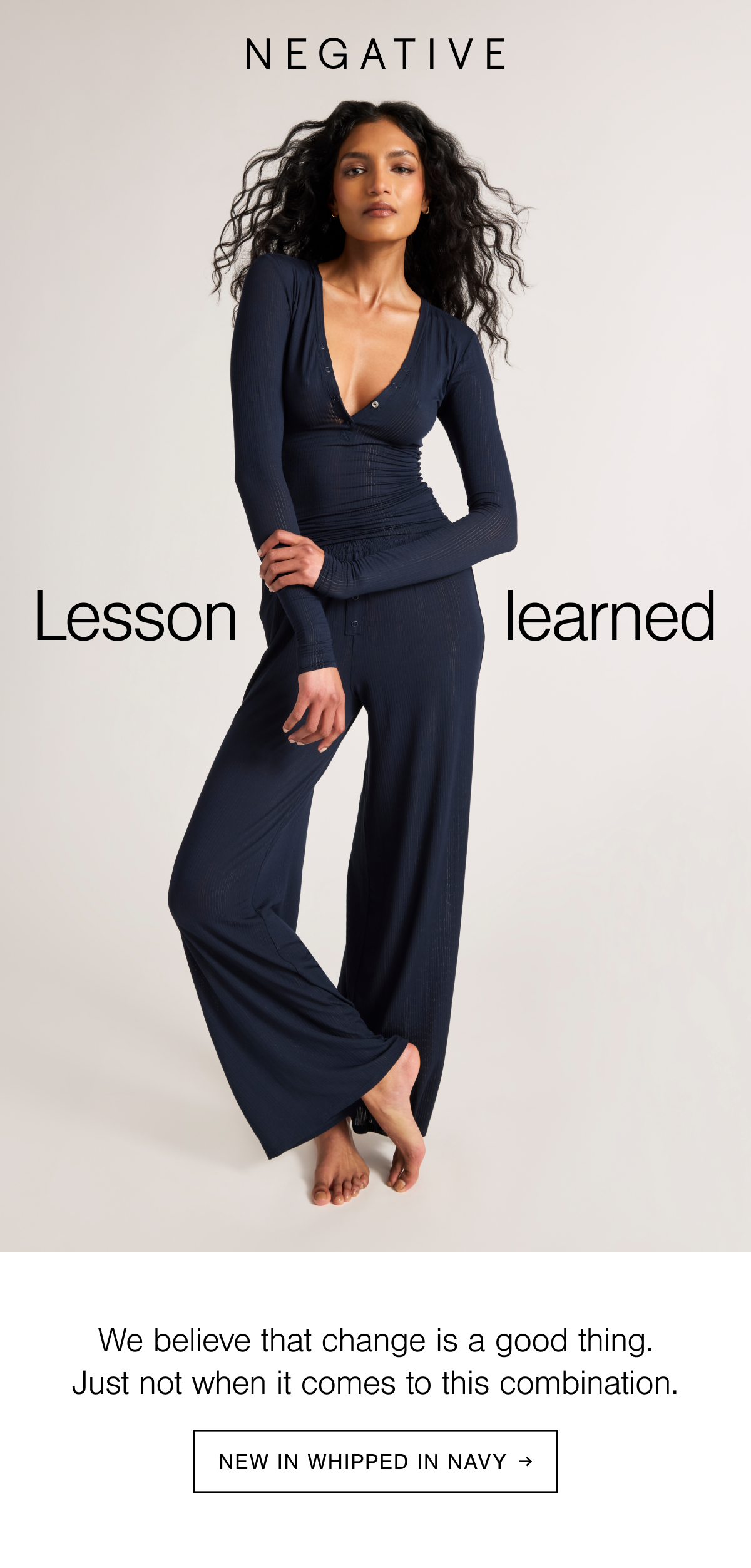 Model wearing the Whipped Henley and Track Pant in Navy. Navy is an inky deep blue tone.