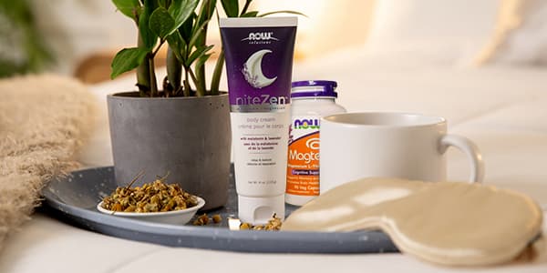 NOW Solutions niteZen Cream on a tray with a tea cup, tea leaves, sleep mask and green plant