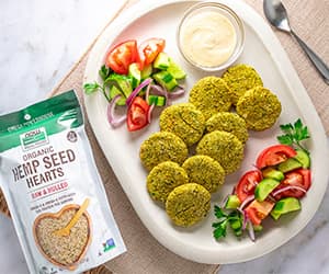 top view of High Protein Baked Falafel Patties next to a bag of NOW Hemp Heart Seeds