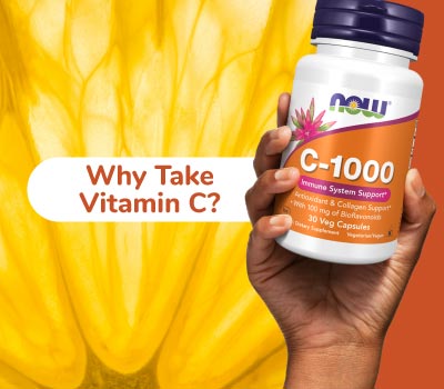 hand holding bottle of NOW C-1000 "Why Take Vitamin C?" 