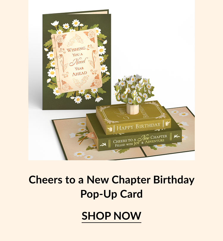 A birthday pop-up card featuring 3d books with text that reads ''Cheers to a new chapter.''