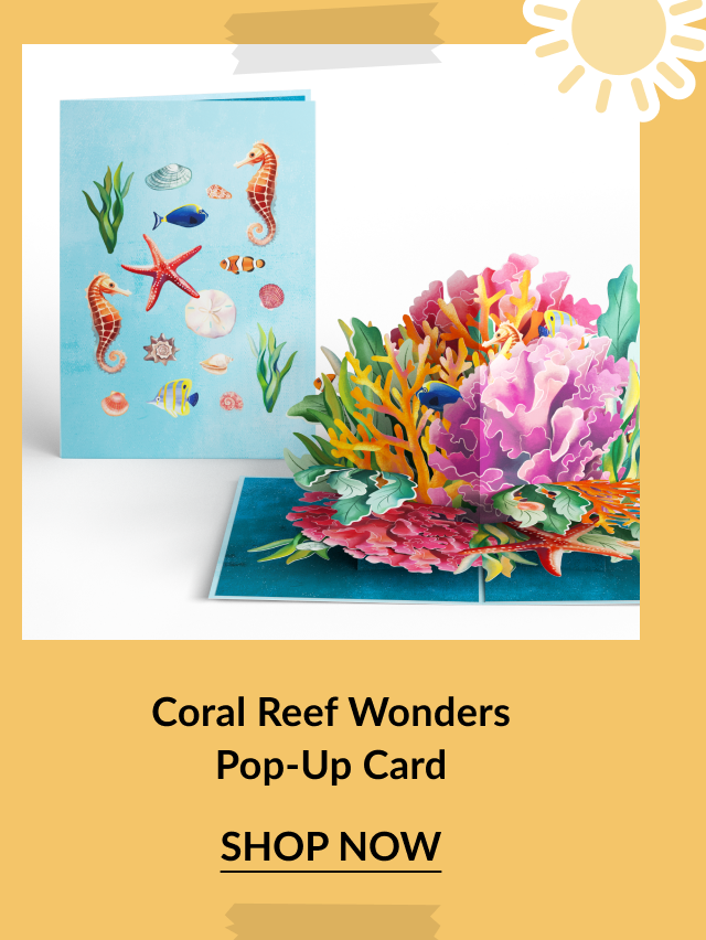 Underwater-themed pop-up card featuring sea creatures on the cover and a vibrant 3D coral reef inside with tropical fish and marine plants. Call-to-action below reads Coral Reef Wonders Pop-Up Card – Shop Now.