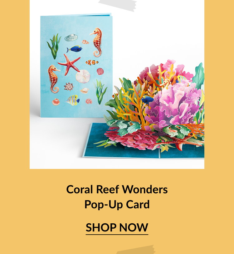 Underwater-themed pop-up card featuring sea creatures on the cover and a vibrant 3D coral reef inside with tropical fish and marine plants. Call-to-action below reads Coral Reef Wonders Pop-Up Card – Shop Now.