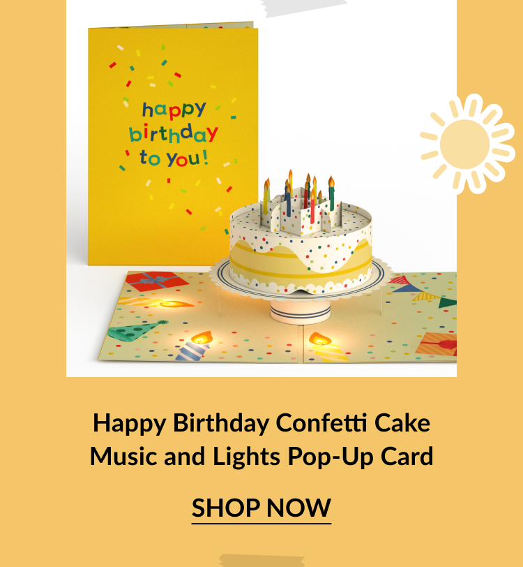 Yellow pop-up birthday card with a colorful cake and lit candles. The interior lights up and plays music. Confetti and party elements decorate the card. Call-to-action below reads Happy Birthday Confetti Cake Music and Lights Pop-Up Card – Shop Now.