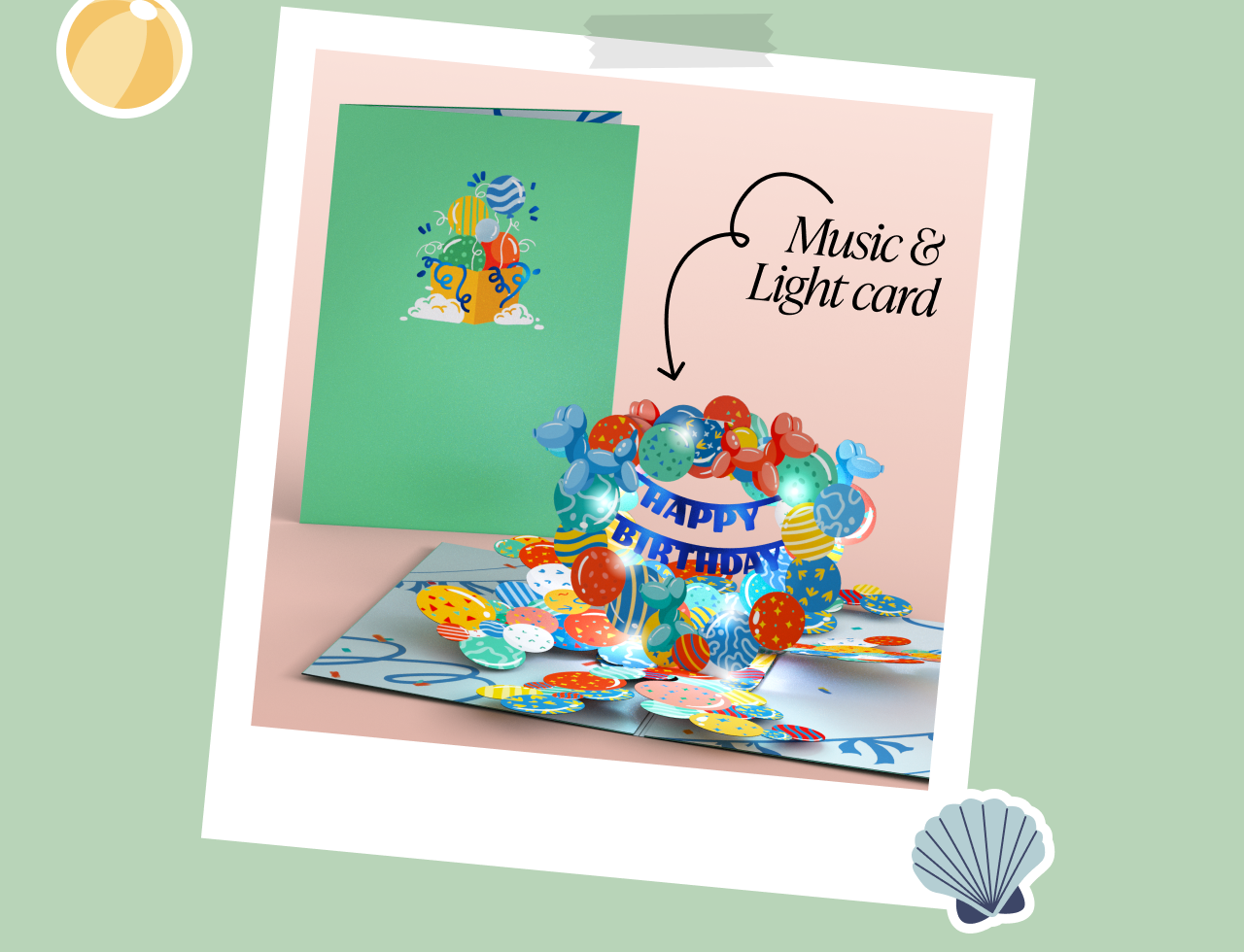 Birthday card with colorful balloons on the cover and a matching 3D pop-up balloon display inside. Lights and music are featured. Label reads Music & Light card with a shell icon in the corner and taped photo frame style.