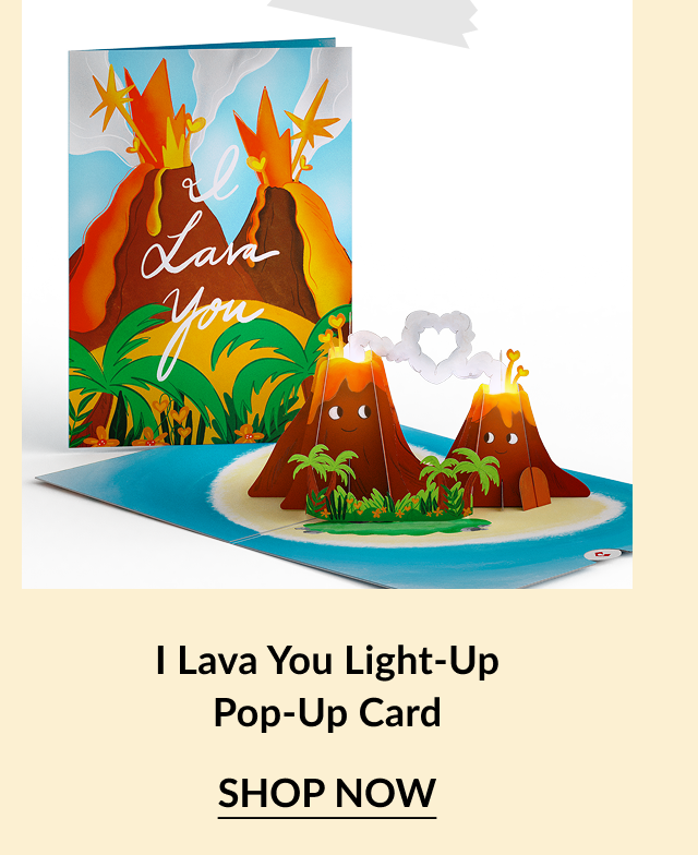 Light-up pop-up card with a volcano design. The cover reads I Lava You and the interior features two smiling volcanoes with a glowing heart-shaped smoke cloud. Call-to-action below reads I Lava You Light-Up Pop-Up Card – Shop Now.