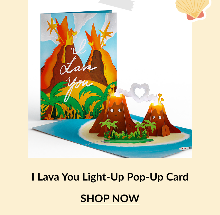 Light-up pop-up card with a volcano design. The cover reads I Lava You and the interior features two smiling volcanoes with a glowing heart-shaped smoke cloud. Call-to-action below reads I Lava You Light-Up Pop-Up Card – Shop Now.