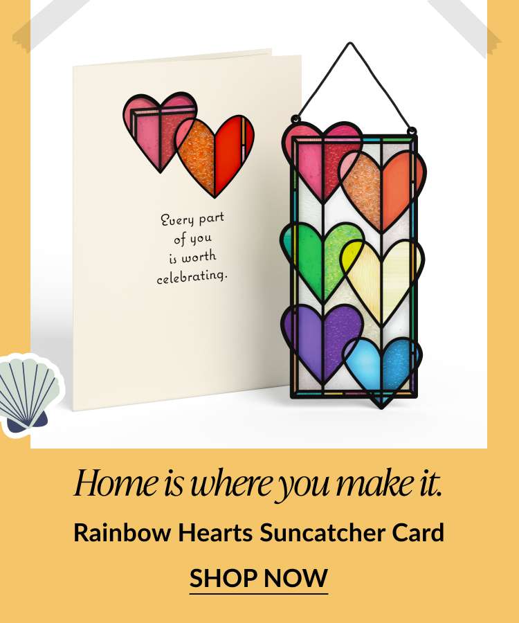 Card with rainbow-colored heart shapes and matching multicolored heart suncatcher. Card reads: 'Every part of you is worth celebrating.' Text below says: 'Home is where you make it. Rainbow Hearts Suncatcher Card.' Button reads 'Shop Now.