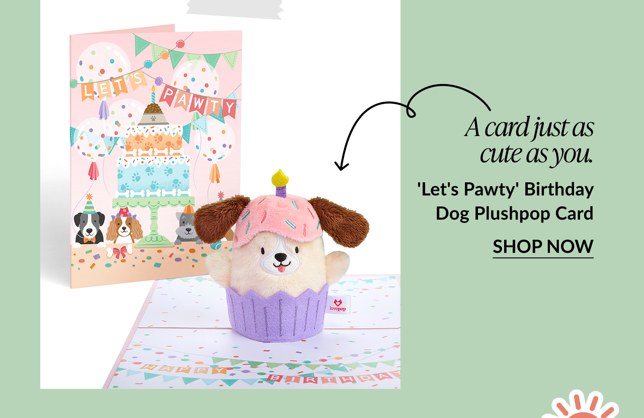 Dog Plushpop in a cupcake wrapper with a pastel party-themed card behind it.
