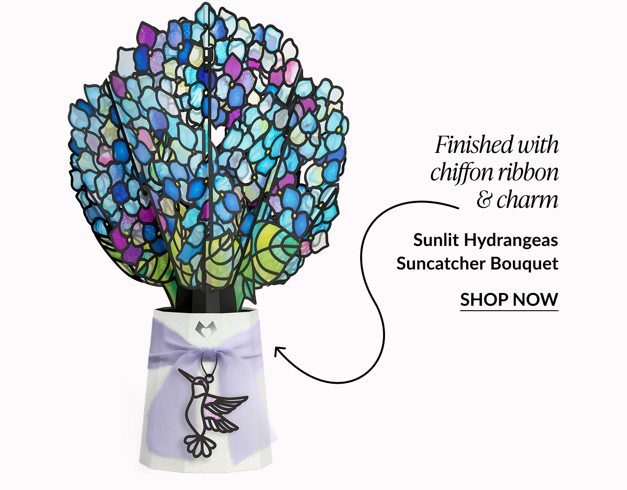 Blue and purple stained-glass hydrangea bouquet with a chiffon ribbon and hummingbird charm.