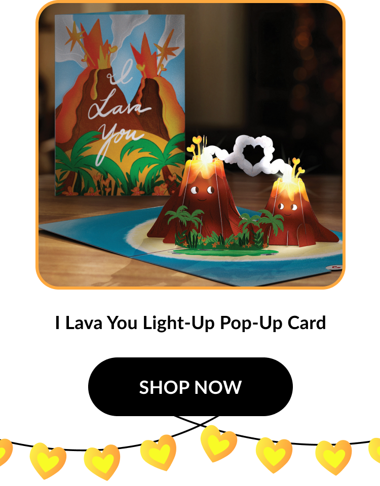 Image of the “I Lava You” card again with a closer view. Two volcanoes smile with glowing lava, surrounded by greenery. Product name: ''I Lava You Light-Up Pop-Up Card''. Button text: ''SHOP NOW''.