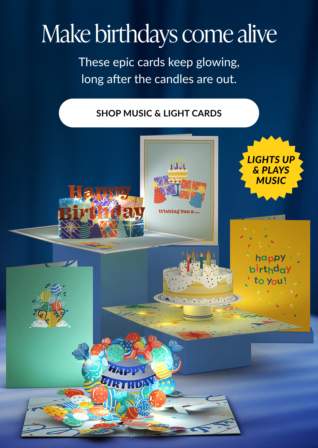 Animated image of several birthday-themed pop-up cards with glowing lights and music icons. Text reads: ''Make birthdays come alive. These epic cards keep glowing, long after the candles are out.'' Button text: ''SHOP MUSIC & LIGHT CARDS''. A yellow starburst badge reads: ''LIGHTS UP & PLAYS MUSIC''.