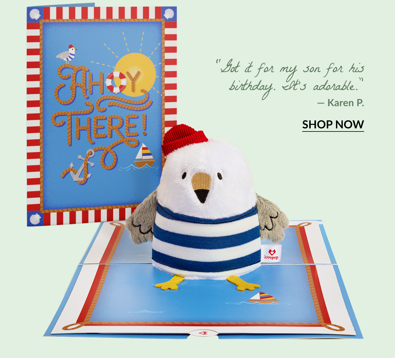 Ahoy There Plushpop Card featuring a plush seagull with red beanie in a pop-up ocean-themed scene. Quote below reads: Got it for my son for his birthday. It’s adorable. — Karen P.