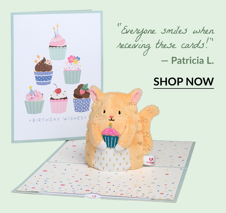 'Birthday Wishes' Cupcake Cat Plushpop Card featuring a soft orange cat holding a cupcake. Quote: Everyone smiles when receiving these cards! — Patricia L.