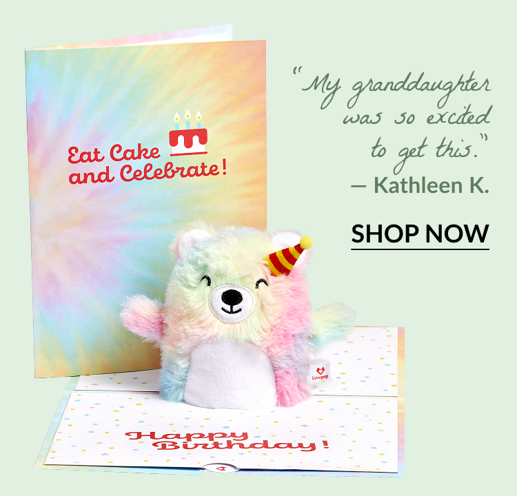 'Eat Cake and Celebrate' Birthday Plushpop Card with a rainbow-colored plush bear wearing a party hat. Quote: My granddaughter was so excited to get this. — Kathleen K.