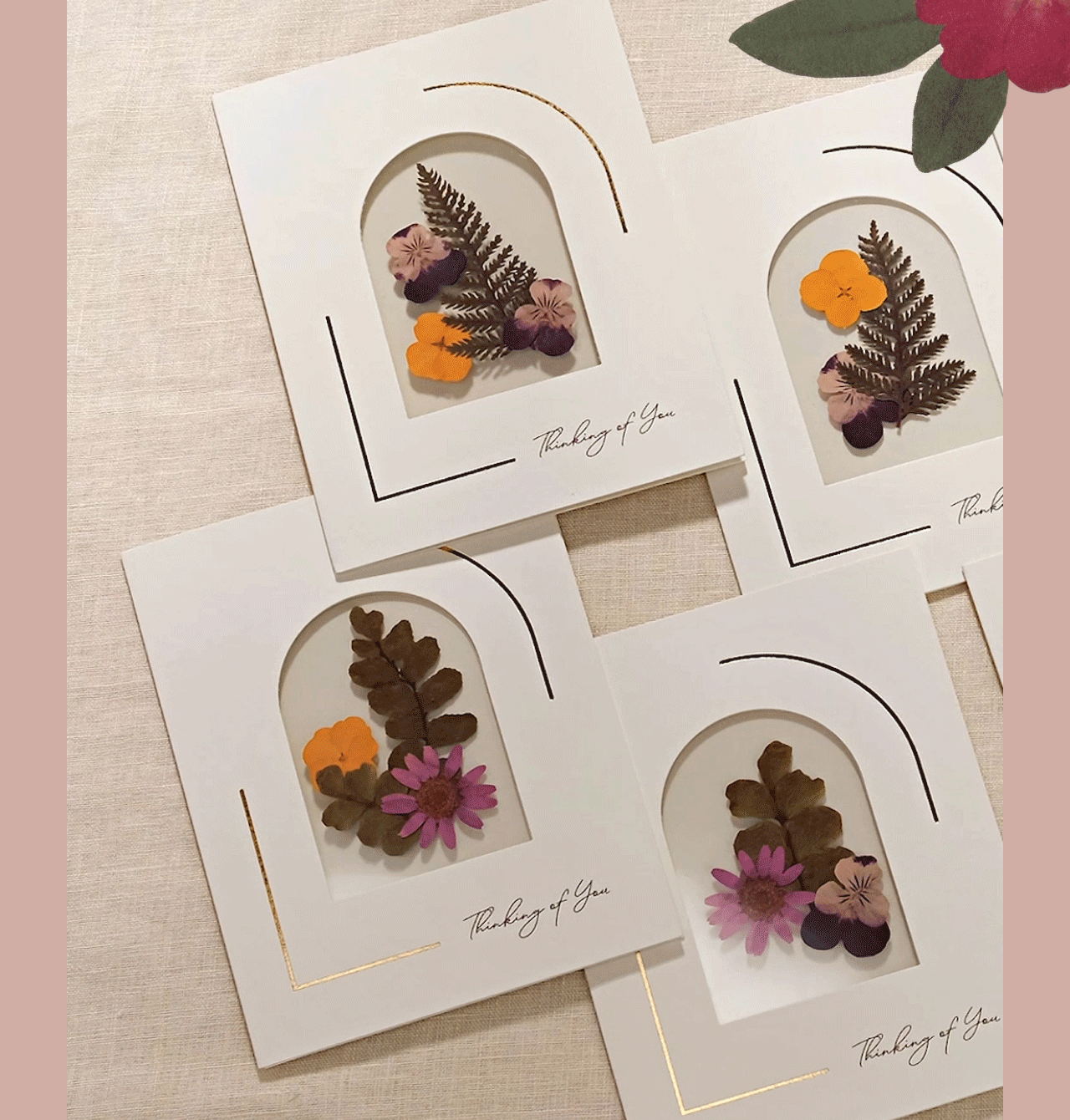 Hand opening the Petal Pressed Notecards box to reveal floral notecards inside.