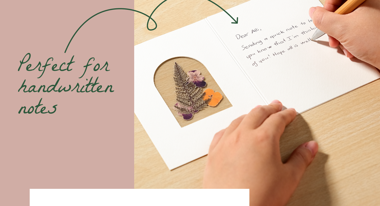 Person writing inside a Petal Pressed notecard featuring lifelike floral details. Perfect for handwritten notes.