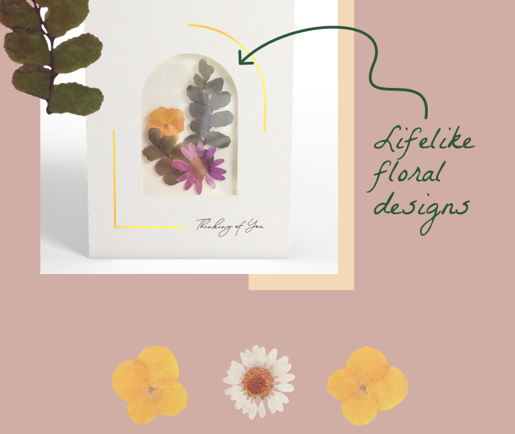 Close-up of Petal Pressed notecard with lifelike pressed flowers and 'Thinking of You' message.