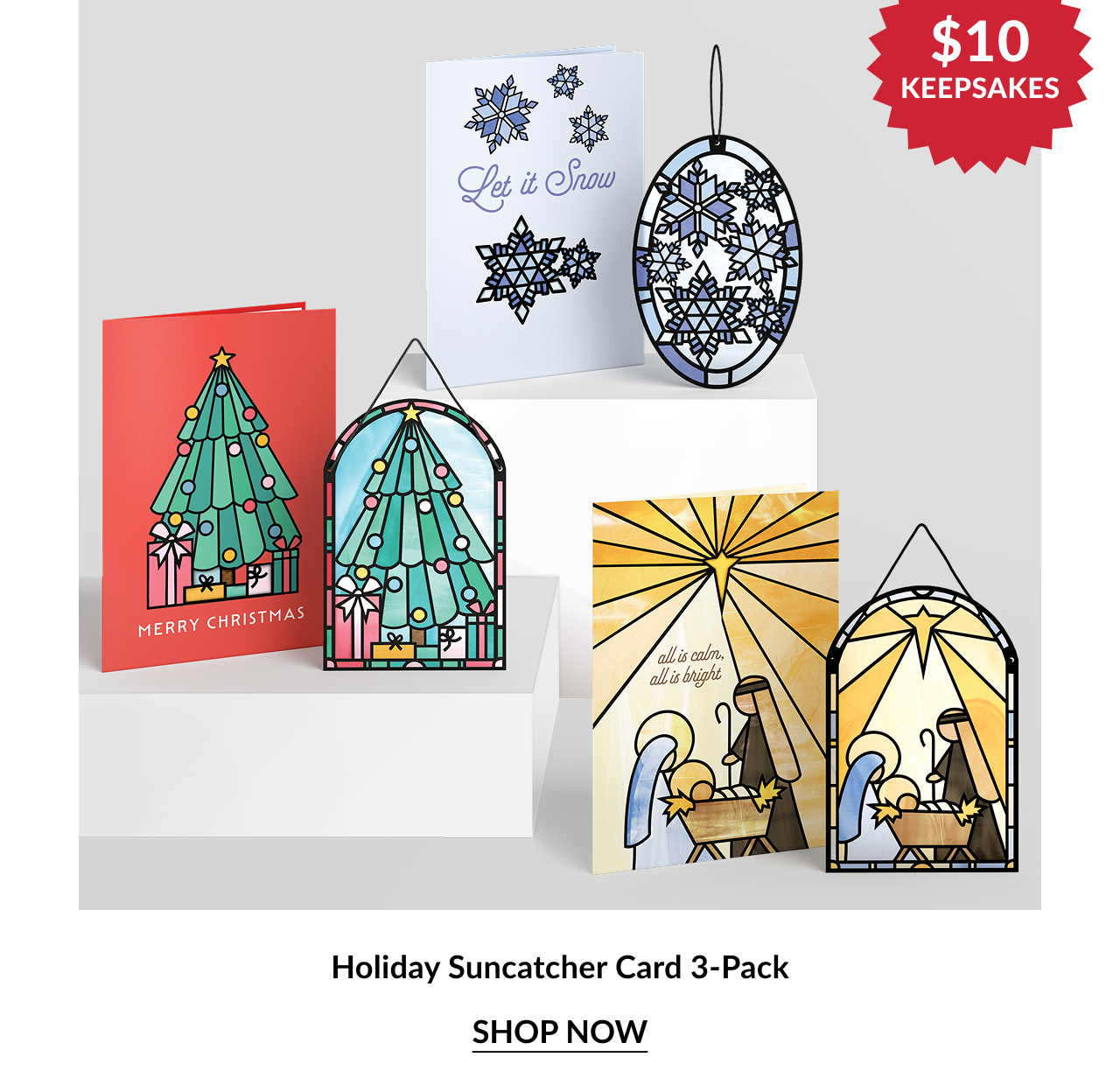 Three holiday-themed cards with matching suncatcher ornaments, including Christmas tree, snowflake, and nativity designs.