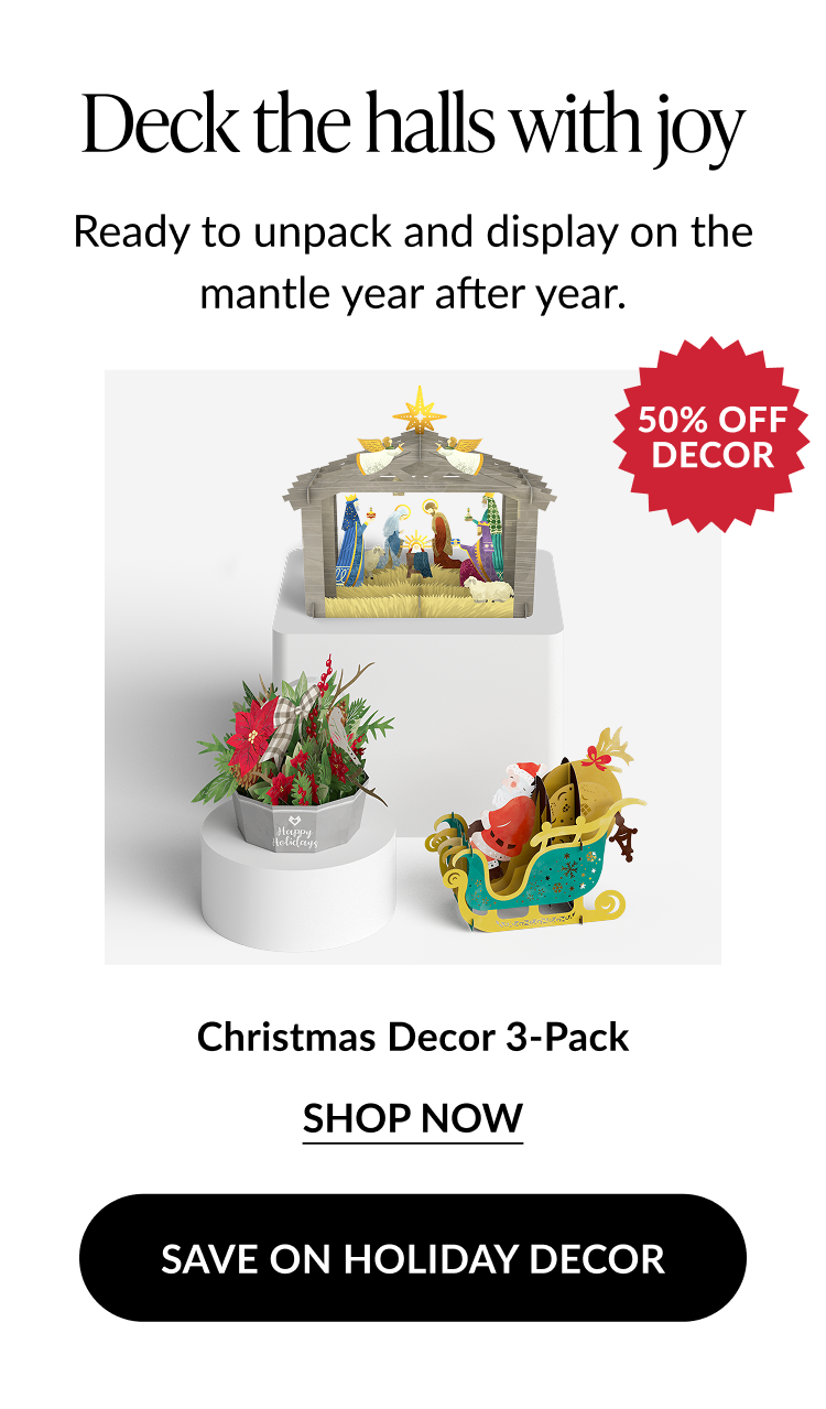 Christmas Decor 3-Pack featuring a nativity scene, poinsettia arrangement, and Santa in a sleigh pop-up display with a “50% Off Decor” badge.
