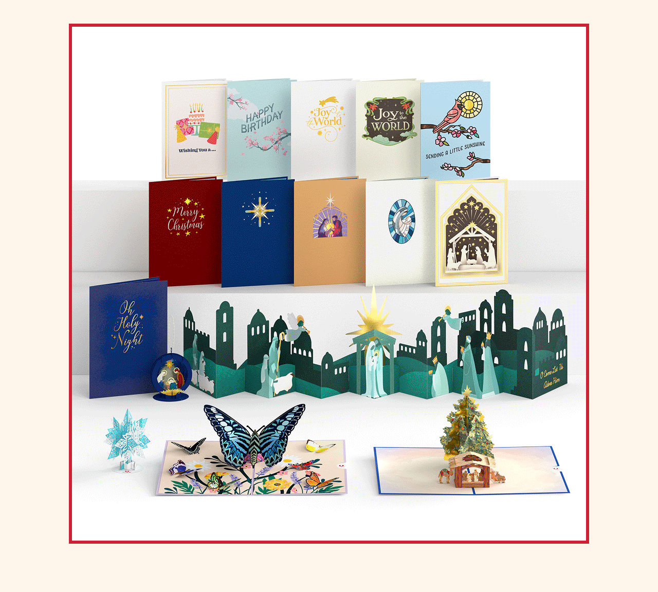 Display of assorted pop-up and flat cards, including nativity scenes, butterflies, and holiday-themed cards.