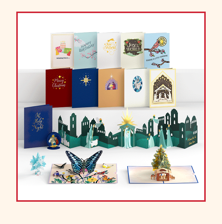 Display of assorted pop-up and flat cards, including nativity scenes, butterflies, and holiday-themed cards.