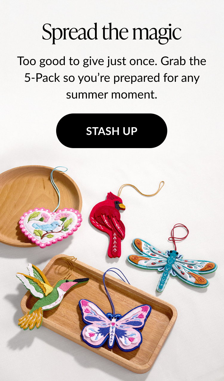 Promotional image with the headline Spread the magic, featuring a collection of five HeartFelt Charms—bluebird, cardinal, dragonfly, hummingbird, and butterfly—displayed on wooden trays.