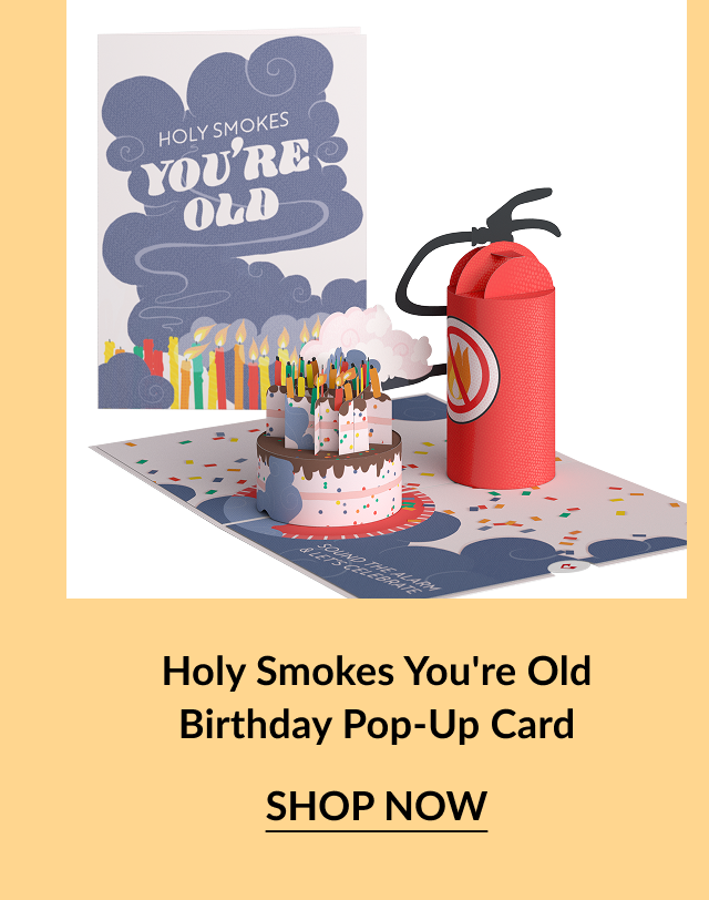 Pop-up birthday card with a cake surrounded by lit candles and a fire extinguisher.