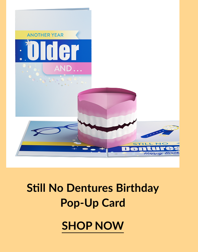 Pop-up birthday card featuring a set of pink dentures on a playful background.