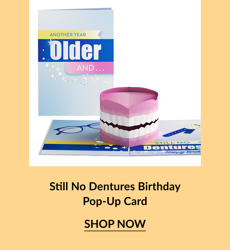 Pop-up birthday card featuring a set of pink dentures on a playful background.