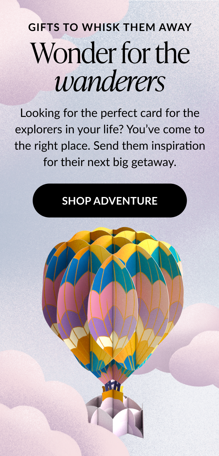 Hot air balloon pop-up card with colorful panels floating among clouds.