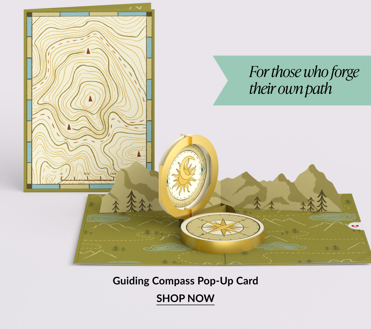 Pop-up card of a compass with a topographic map.
