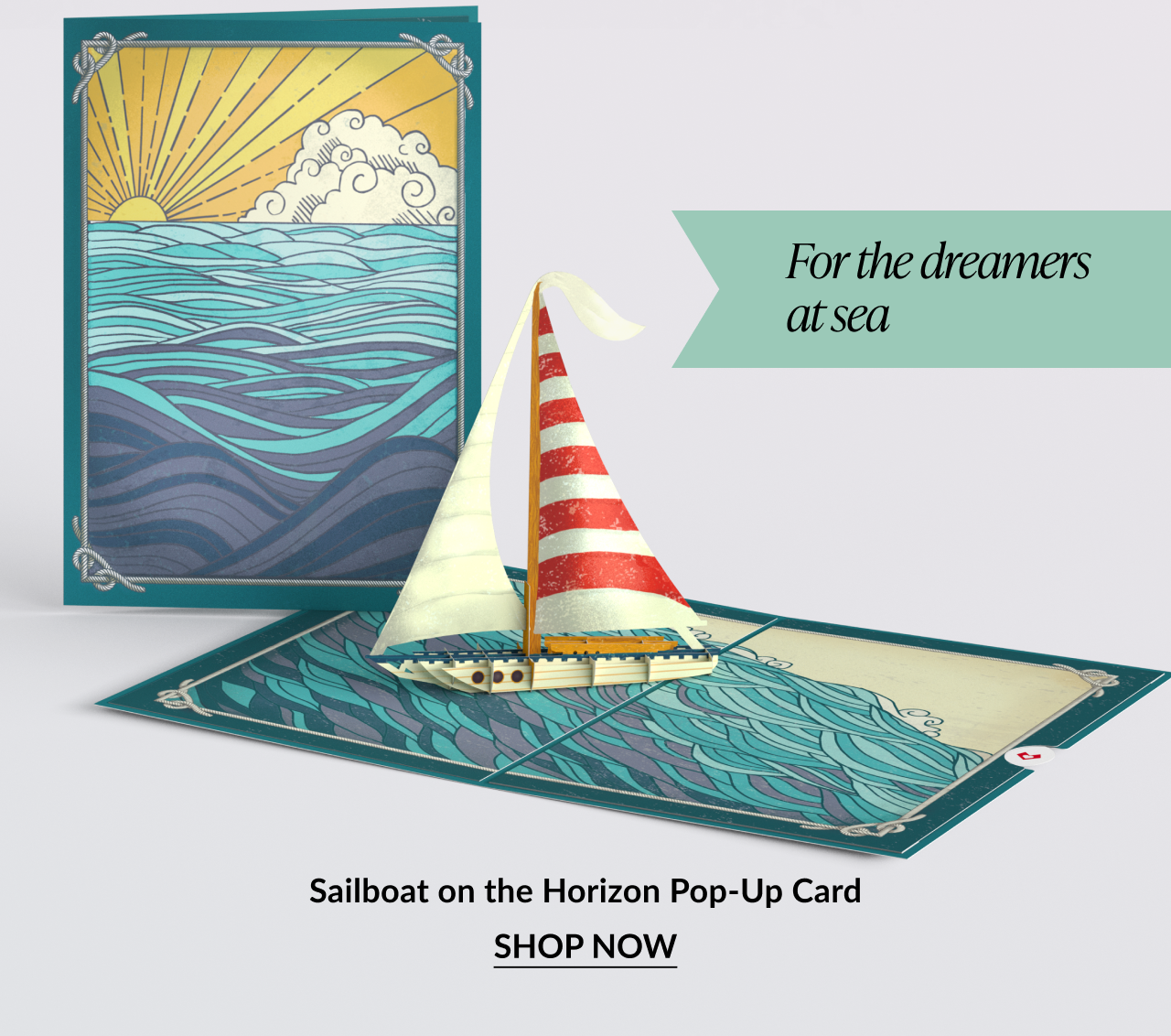 Pop-up card of a sailboat on the ocean with sunset art.