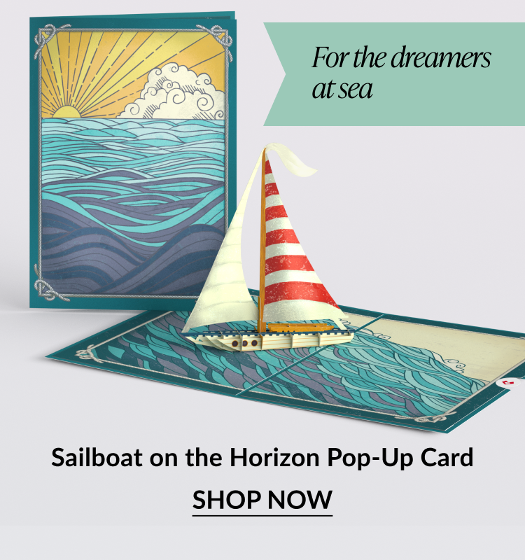 Pop-up card of a sailboat on the ocean with sunset art.
