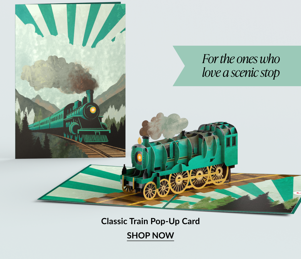 Pop-up card of a green steam train on tracks.