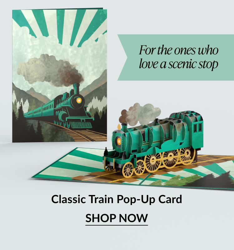 Pop-up card of a green steam train on tracks.