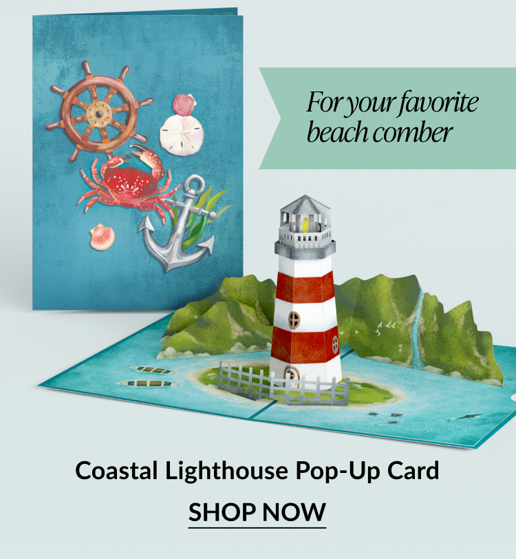 Pop-up card of a red and white lighthouse on a rocky island.
