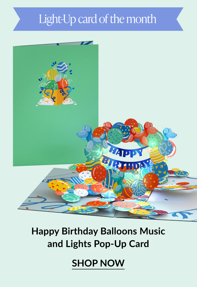 Light-up pop-up birthday card with colorful balloons and a “Happy Birthday” banner. Button: “Shop Now”