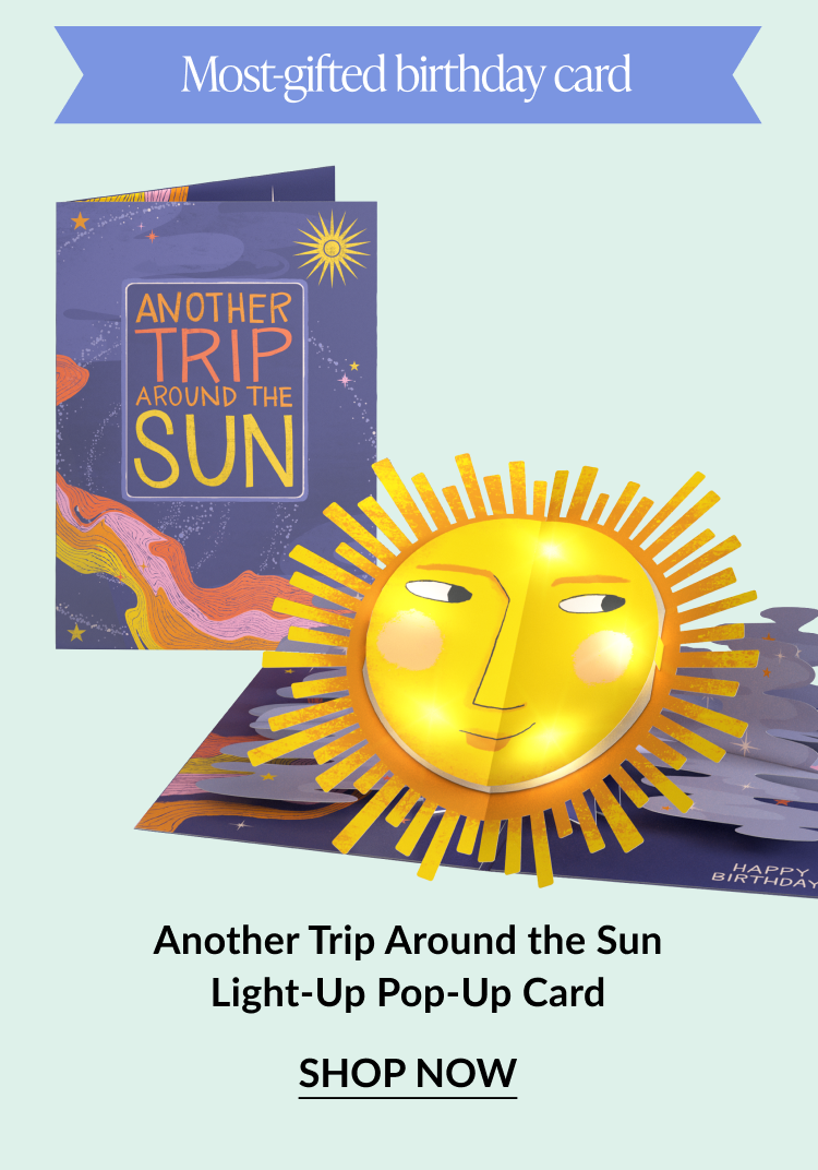 Light-up birthday pop-up card with a stylized sun and galactic background. Button: “Shop Now”
