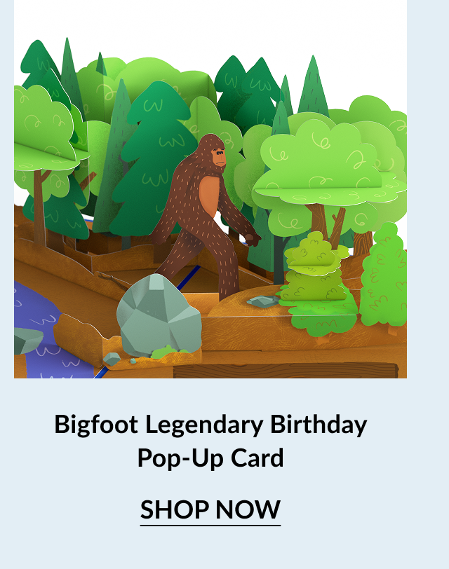 Pop-up birthday card showing Bigfoot walking through a forest with trees, rocks, and a river