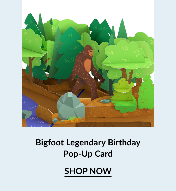 Pop-up birthday card showing Bigfoot walking through a forest with trees, rocks, and a river