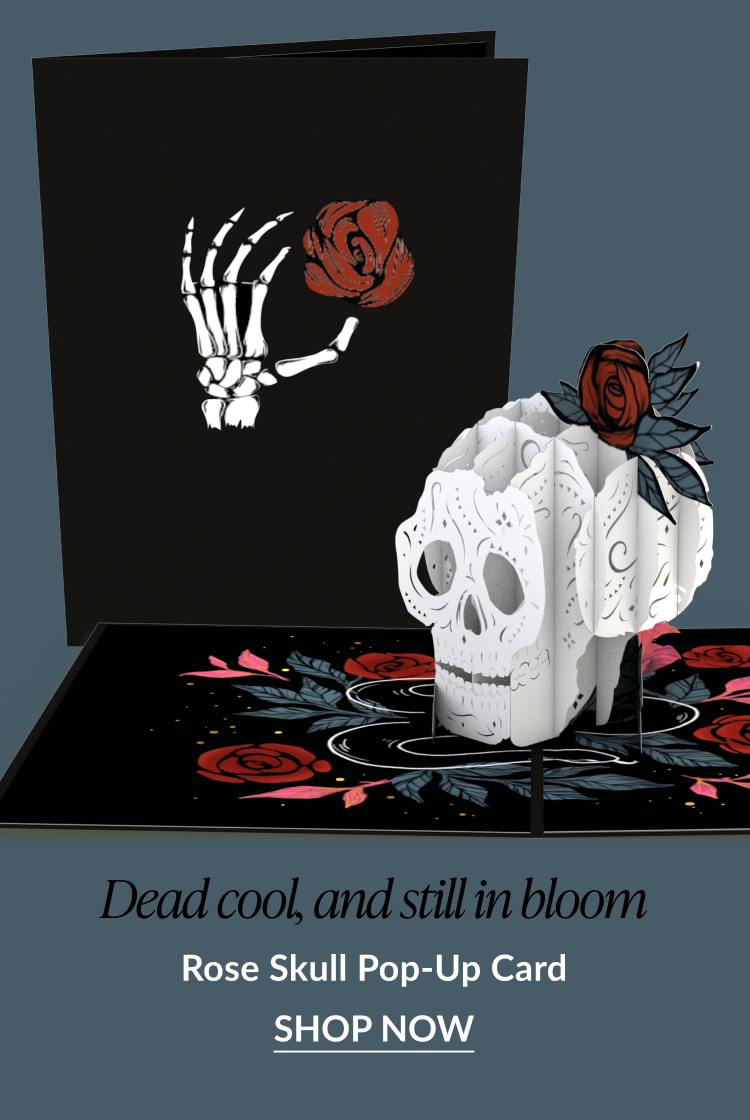 Rose Skull pop-up card with a white 3D skull, red roses, and a skeletal hand holding a flower on the cover