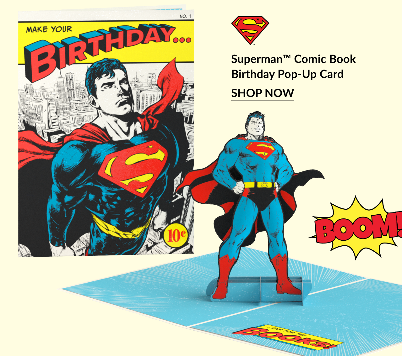 Superman Comic Book Birthday Pop-Up Card featuring a retro comic book cover design and a 3D pop-up Superman figure, with “Boom!” text graphic and “Shop Now” button.