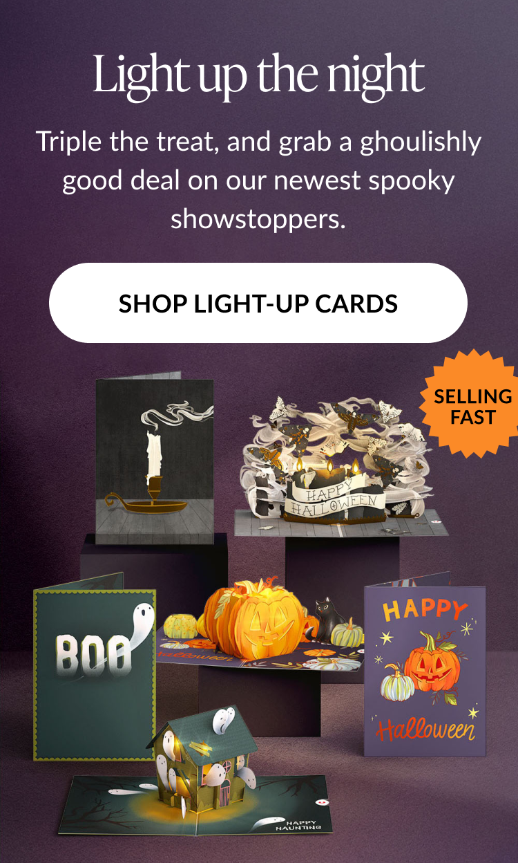 Light Up the Night section featuring illuminated Halloween pop-up cards, including pumpkins, ghosts, and Happy Halloween card. CTA: Shop Light-Up Cards.
