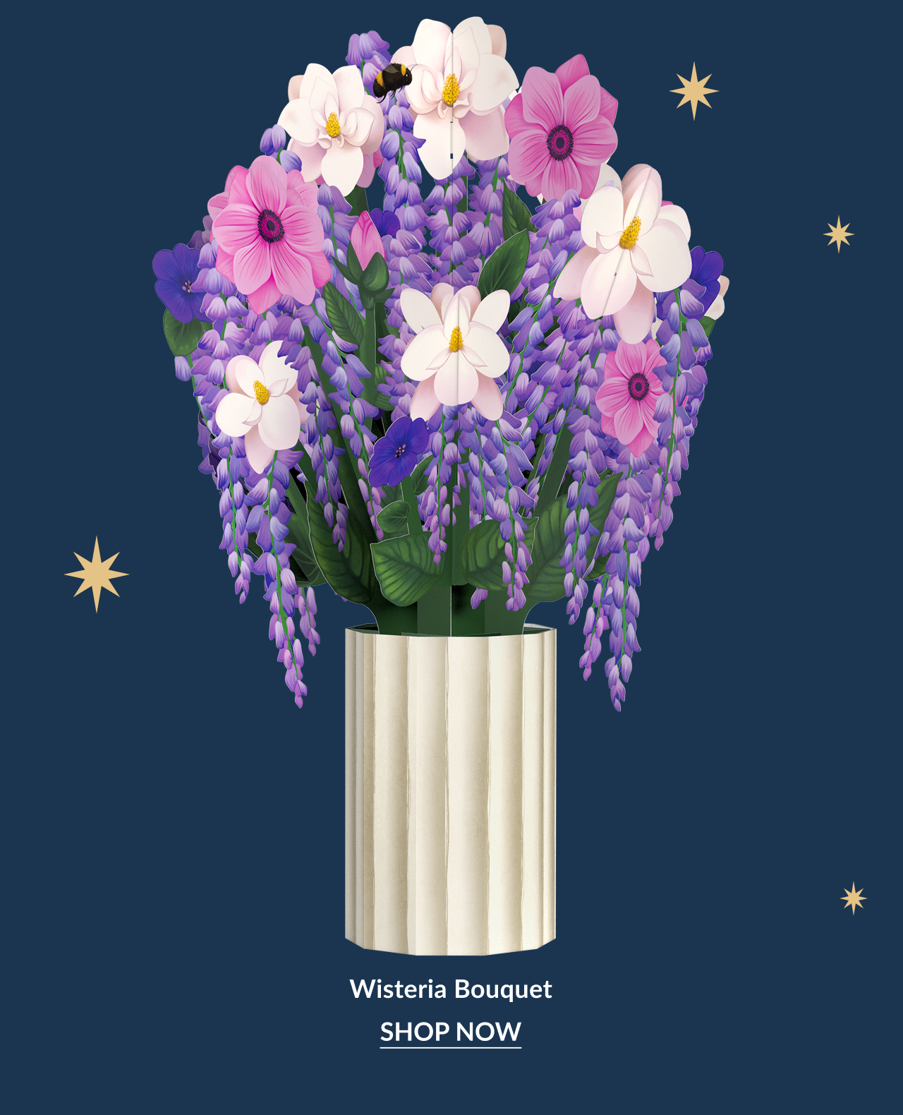 Wisteria Bouquet paper flowers in a cream vase with purple and pink blooms