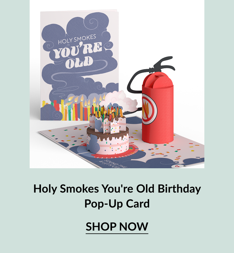 Holy Smokes You’re Old Birthday Pop-Up Card with cake full of candles and red fire extinguisher. Button: Shop now