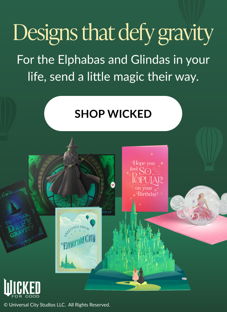 Wicked card collection featuring pop-ups of Elphaba Glinda and Emerald City Text says Designs that defy gravity send a little magic their way Button says Shop Wicked