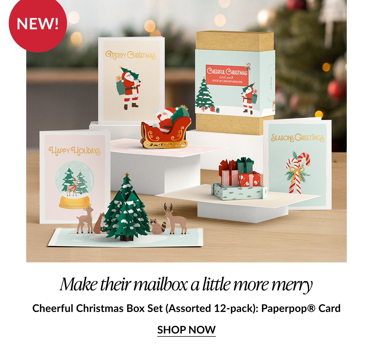 Christmas-themed box set display with Santa, reindeer, tree, gifts, and candy cane cards; labeled “Cheerful Christmas Box Set.”